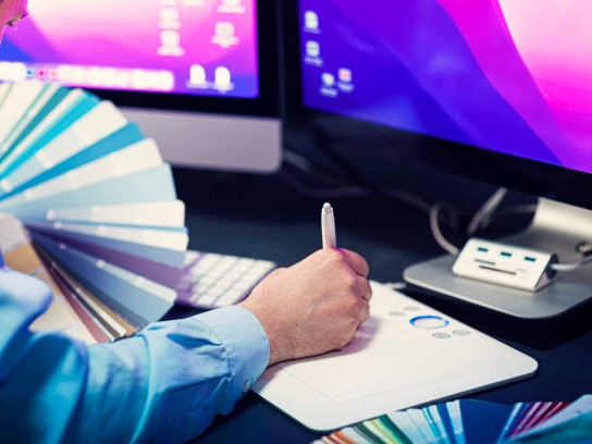 Graphic designer drawing on graphics tablet